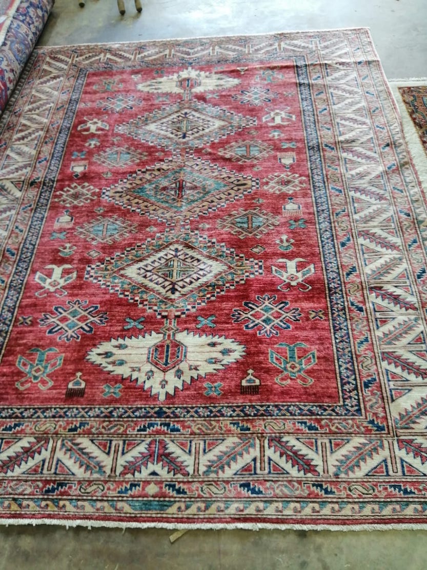 A Caucasian style red ground rug, 236 x 184cm